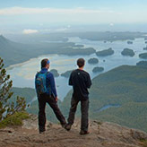 Two hikers overlooking Tofino